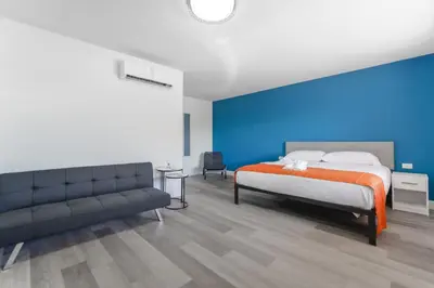a bedroom with a bed and a couch at Amazing unit with pool & parking at the beach - M35 in Hollywood