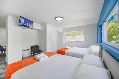 a bedroom with two beds and a flat screen tv at Outstanding oceanfront unit With Parking&Pool - M36 in Hollywood