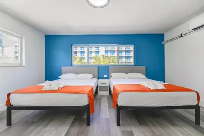 two beds in a room with blue walls at Outstanding oceanfront unit With Parking&Pool - M36 in Hollywood
