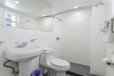 a white bathroom with a toilet and a sink at Magical Beach Escape with Pool -M37 in Hollywood