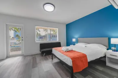 a bedroom with a bed and a blue wall at Ocean view Balcony with Pool & Parking -M42 in Hollywood