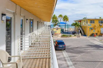 a balcony with chairs and a car parked on the street at Ocean view Balcony with Pool & Parking -M42 in Hollywood