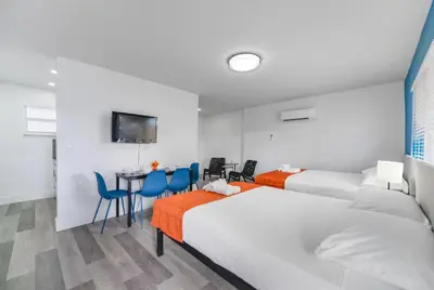 a hotel room with two beds and a table and chairs at Fantastic Studio at the Beach with Parking&Pool - M43 in Hollywood