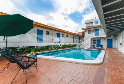 a swimming pool with an umbrella next to a building at Fantastic Studio at the Beach with Parking&Pool - M43 in Hollywood