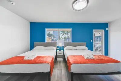 two beds in a room with blue walls at Unit with Balcony and Parking at the beach -M45 in Hollywood