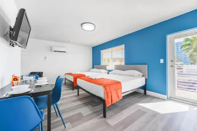 a bedroom with a bed and a dining room with a table at Unit with Balcony and Parking at the beach -M45 in Hollywood