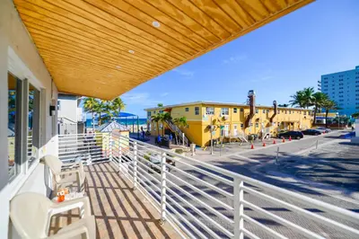 a balcony with a white railing and a yellow building at Spacious studio with Balcony and Parking at the Beach -M46 in Hollywood