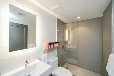 a bathroom with a sink and a toilet and a shower at The Julia Hotel in Miami Beach