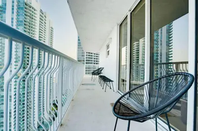 a balcony with chairs and windows in a building at Iconic Sunset Views with Pool, Hot tub, GYM, and Parking in Miami