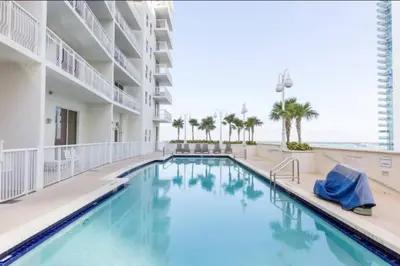 a swimming pool in a hotel with the ocean in the background at Iconic Sunset Views with Pool, Hot tub, GYM, and Parking in Miami