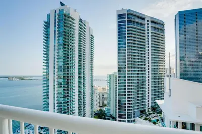 a view of some tall buildings from a balcony at Iconic Sunset Views with Pool, Hot tub, GYM, and Parking in Miami