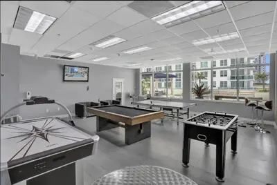 a large room with several ping pong tables in it at Iconic Sunset Views with Pool, Hot tub, GYM, and Parking in Miami