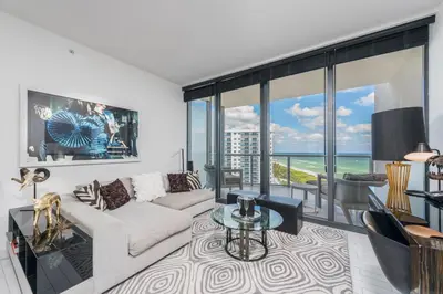 a living room with a couch and a table at Stunning 3B Oceanfront at South Beach - 1229 in Miami Beach