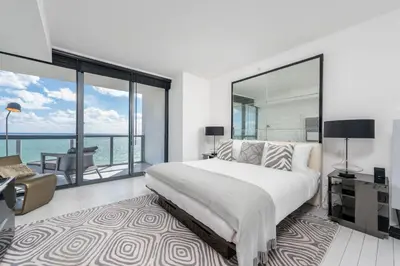 a bedroom with a large bed and a large window at Stunning 3B Oceanfront at South Beach - 1229 in Miami Beach