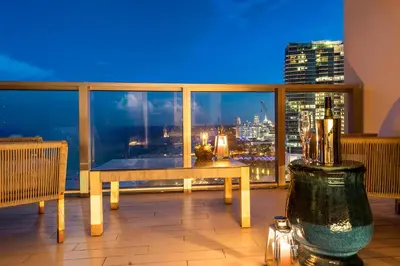 a balcony with a view of a city at night at PENTHOUSE Ocean View Residence at South Beach - 1926 in Miami Beach