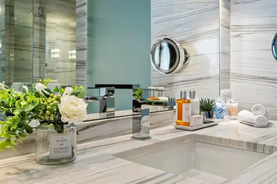 a bathroom with a sink and a large mirror at PENTHOUSE Ocean View Residence at South Beach - 1926 in Miami Beach