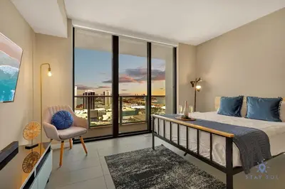 a bedroom with a bed and a balcony with a view at Modern Miami Gem - City View Condo - Free Parking in Miami