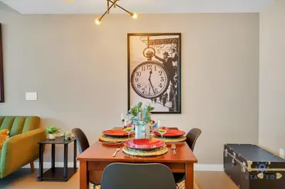 a dining room with a table with a clock on the wall at Modern Miami Gem - City View Condo - Free Parking in Miami