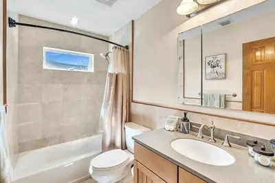 a bathroom with a sink and a toilet and a mirror at Pool Heat I Firepit and BBQ I 75