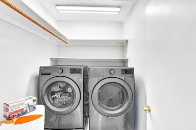a laundry room with two washing machines in it at Pool Heat I Firepit and BBQ I 75