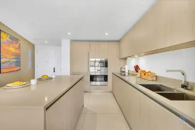 a large kitchen with a counter and a sink at Insane Ocean View Balcony, Beachfront Resort, Pool in Hollywood