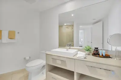a white bathroom with a toilet and a sink at Insane Ocean View Balcony, Beachfront Resort, Pool in Hollywood