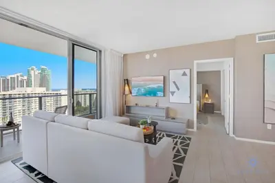 a living room with a white couch and large windows at High Floor with Stunning Views, Amazing Pools in Hollywood