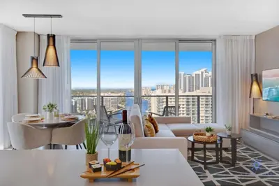 a living room with a white couch and large windows at High Floor with Stunning Views, Amazing Pools in Hollywood