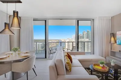 a living room with a couch and a table at High Floor with Stunning Views, Amazing Pools in Hollywood