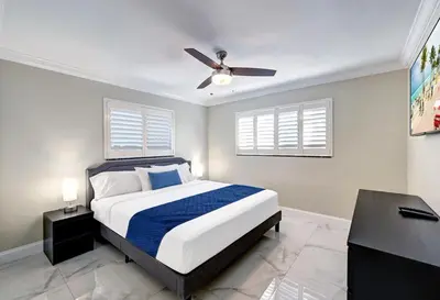 a bedroom with a bed and a ceiling fan at Deluxe 5BR & 3BA Villa in Hollywood Lakes near Beach in Hollywood