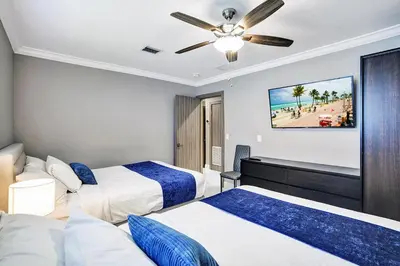 a hotel room with two beds and a ceiling fan at Spectacular 5BR & 5BA Villa in Hollywood Lakes in Hollywood