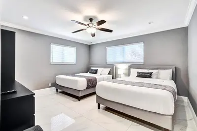 a bedroom with two beds and a ceiling fan at Spectacular 5BR & 5BA Villa in Hollywood Lakes in Hollywood