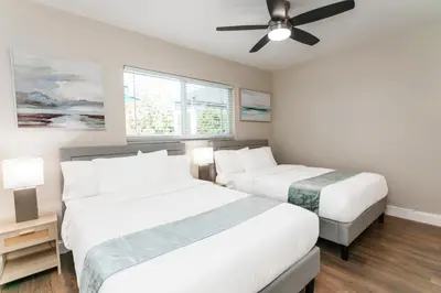 a bedroom with two beds and a ceiling fan at Luxury 5BR Villa Heated Pool near Beach & Casino in Dania Beach