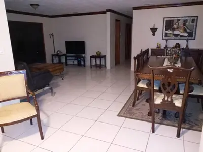 a living room with a table and chairs at Pool home in Miami in Tamiami