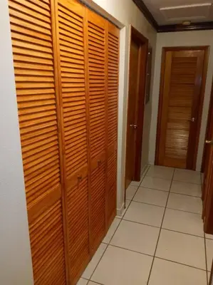 a hallway with wooden closets in a house at Pool home in Miami in Tamiami