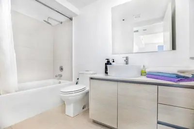 a white bathroom with a sink and a toilet at Beachwalk Resort - Waterfront huge 3-Bedroom apartment with direct ocean-view! in Hallandale Beach