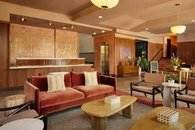 a living room with a couch and tables and chairs at FOUND Hotels, Miami Beach, Series by Marriott in Miami Beach