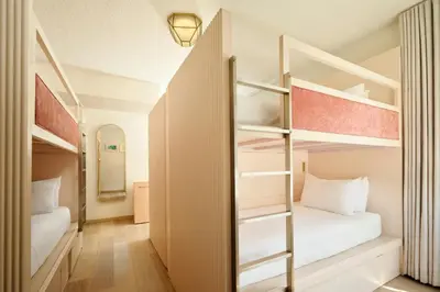 a room with two bunk beds and a mirror at FOUND Hotels, Miami Beach, Series by Marriott in Miami Beach