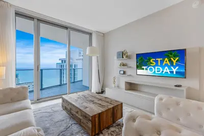 a living room with a tv and a large window at Hyde Resort Beachfront Condo #1904 - GORGEOUS 2BD & 2BA APT WITH OCEAN VIEW in Hollywood