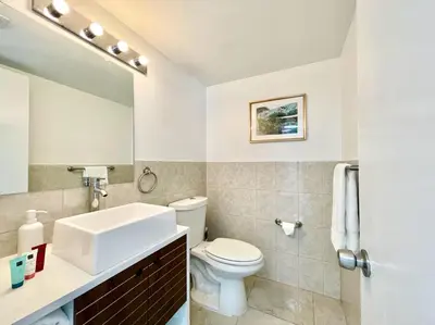 a bathroom with a white toilet and a sink at Large 1 bedroom apartment with free private parking in Miami Beach