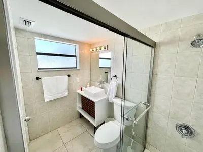 a bathroom with a shower and a toilet and a sink at Large 1 bedroom apartment with free private parking in Miami Beach