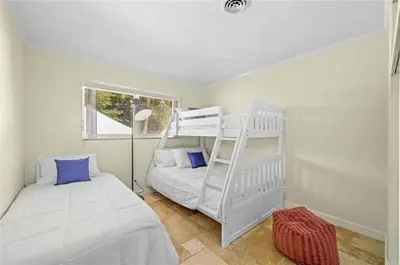 a bedroom with a bunk bed and a ladder at Home wpool by PMI unit 332 in Fort Lauderdale