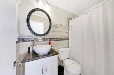 a bathroom with a sink and a toilet and a mirror at Home wpool by PMI unit 332 in Fort Lauderdale