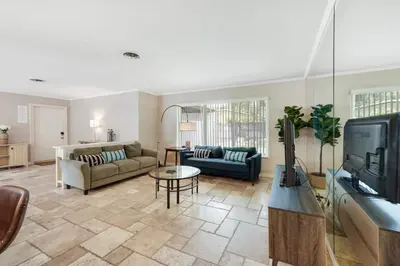 a living room with a couch and a tv at Home wpool by PMI unit 332 in Fort Lauderdale