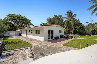 a white house with a patio and a yard at Home wpool by PMI unit 332 in Fort Lauderdale