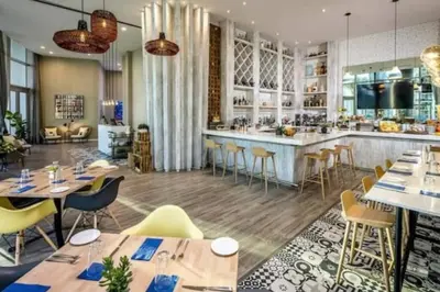 a restaurant with tables and chairs and a bar at Amazing apartment - Lyfe Resort & Resident in Hollywood