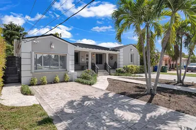 a house with palm trees in front of it at Casa la Miami - Central location Villa with Pool & Gym in Miami