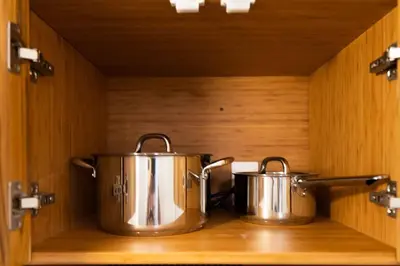two pots sitting on top of a wooden shelf at Elegant Miami Apartment East Little Havana / Free Parking in Miami