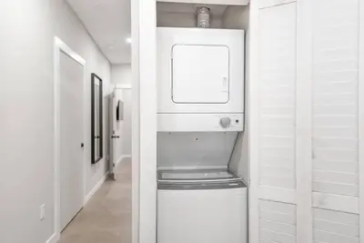 a bathroom with a washer and dryer in a room at Elegant Miami Apartment East Little Havana / Free Parking in Miami