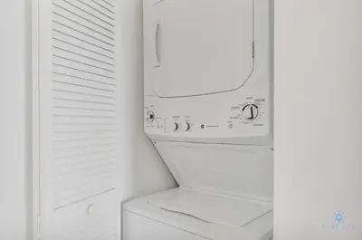 a washer and dryer in a white laundry room at Spectacular Balcony - Near Beach - Gym - Pool in Hallandale Beach